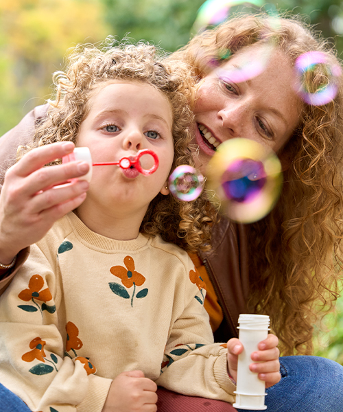 mom and son blowing bubbles